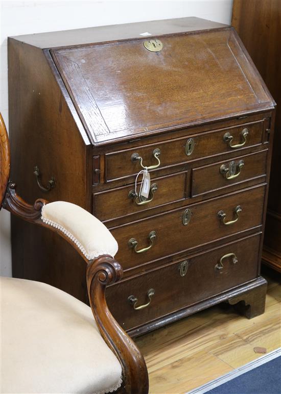 A George II style oak bureau of small proportions W.74cm.